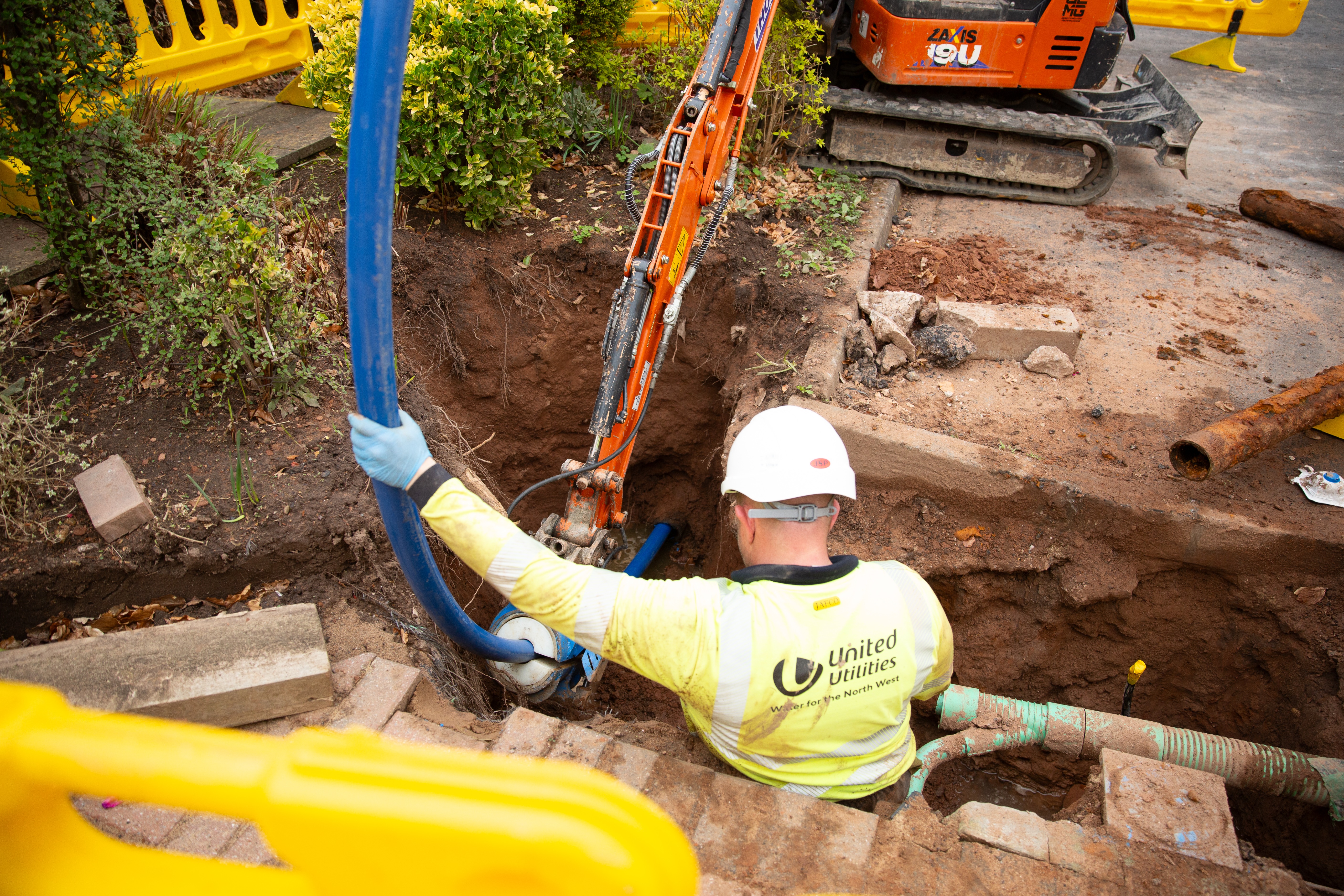 Workers digging up road