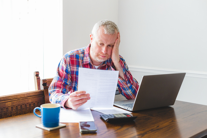 Man looking at bills